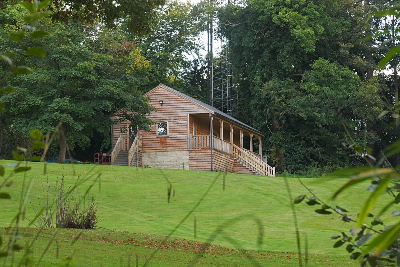 The clubhouse at Moore Place, Esher, with the telecoms mast behind it, from when the course was open. The application covers demolition of the existing structures.